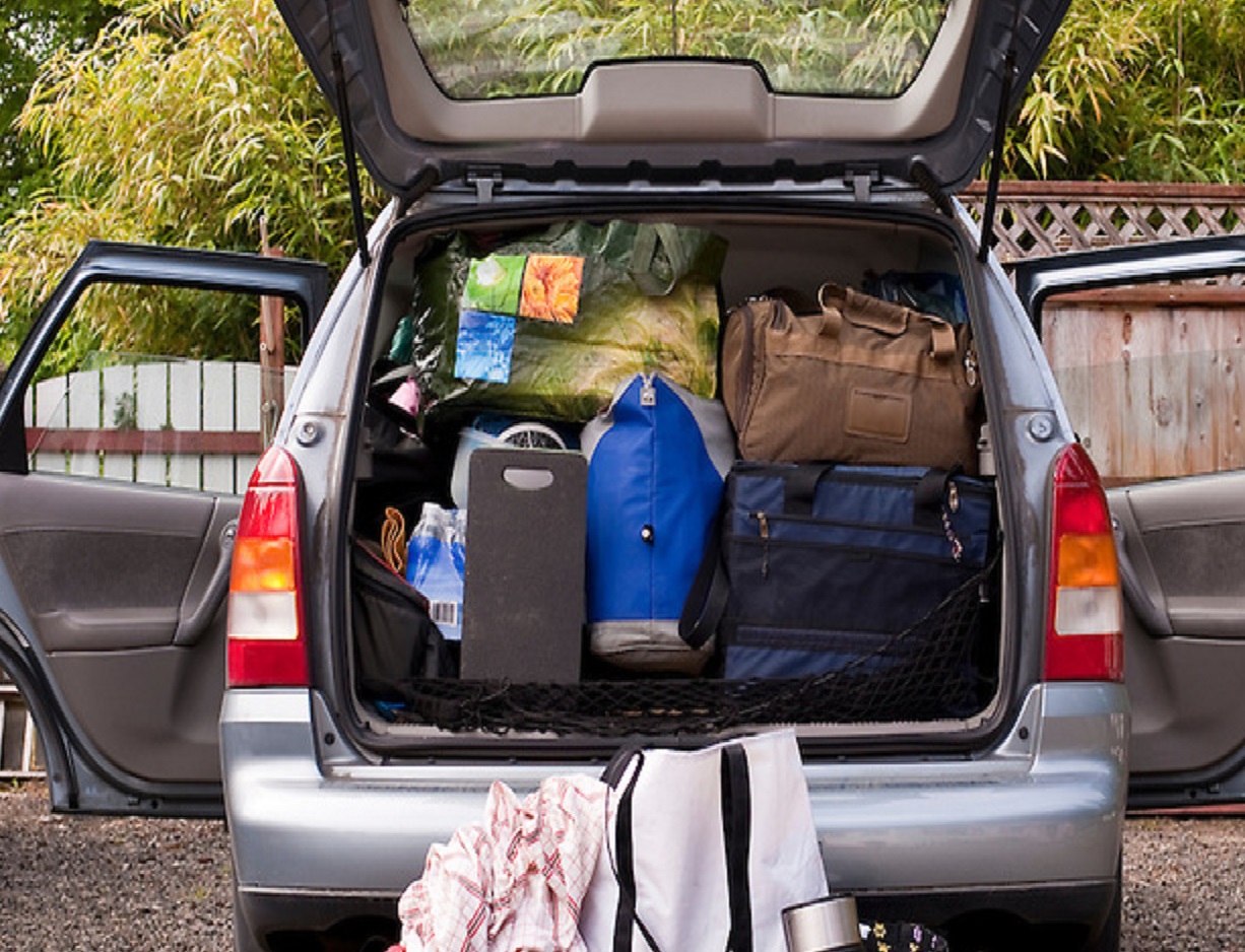 Family on vacation with their automobile packed with suitcases, bags, blankets and more Westport Washington State